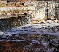 Photo showing a a dam in an urban setting.