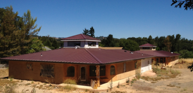 Example of two homes built with Green Building practices including: evens that extend from the main structure to shade windows in summer, and a cupula on the roof to allow summer heat to escape.