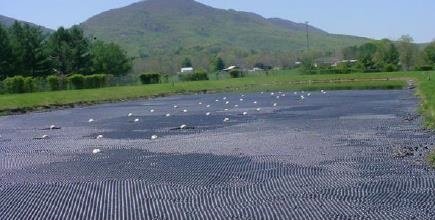 A water treatment lagoon with sun-shielding plastic balls.