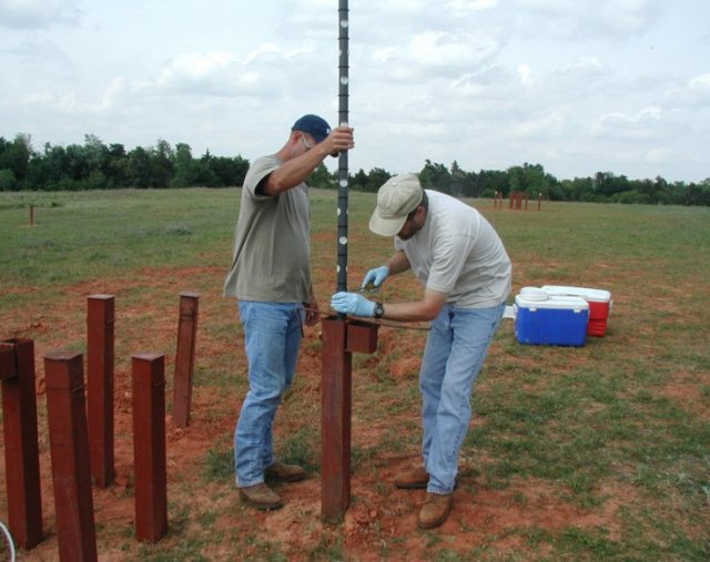 EPA geochemist Rick Wilkin and a field technician installing multi-level passive diffusion samplers at a field site in Oklahoma.