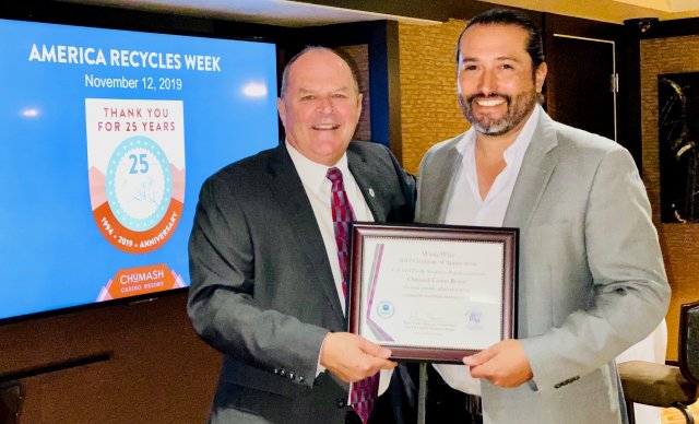 EPA Region 9 Regional Administrator Mike Stoker stands with representative of the Chumash Nation holding an award.