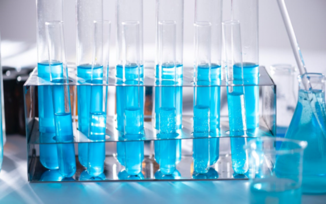 Photograph of a series of test tubes, filled with blue liquid