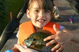 Presenting a fish to a little girl