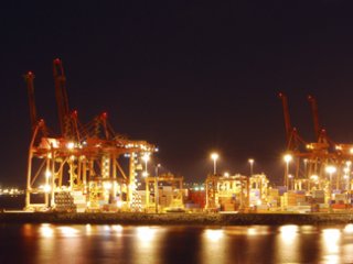 A photograph of port with lights on at night.