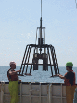 Scientists deploying the multi-corer off the R/V Lake Guardian in Lake Erie to collect sediment core samples.