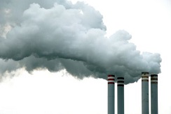 White steam emitting from four smoke stacks