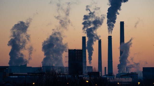 View of multiple emitting smoke stacks at twilight. 