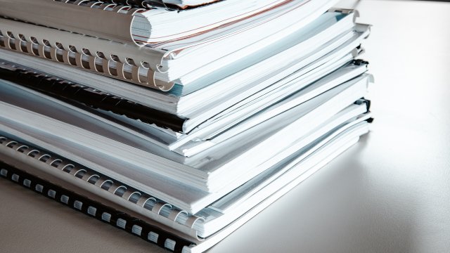 Pile of documents sitting on a table