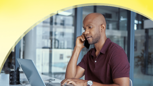 a man on the phone and computer