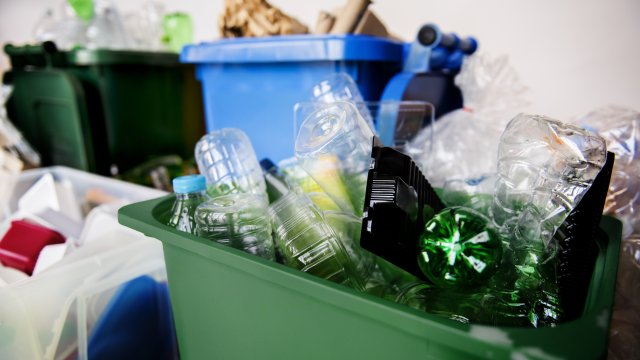 This is a recycling bin with plastic bottles 