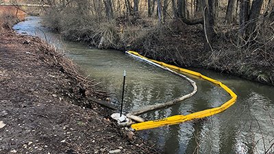 creek with a yellow boom placed