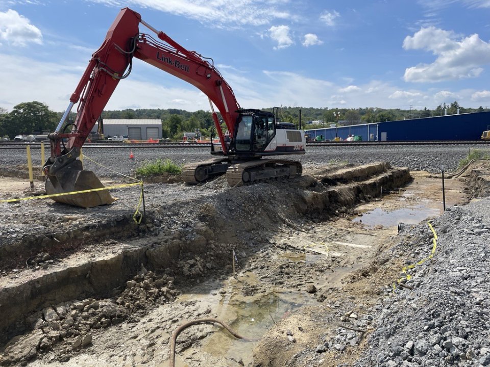 Large machinery excavating pit in Car Scrapping Area 3