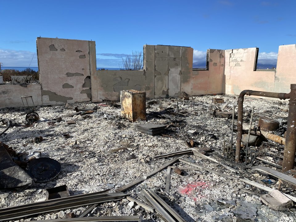 The ash and debris footprint of a burned building before soil stabilizer application.