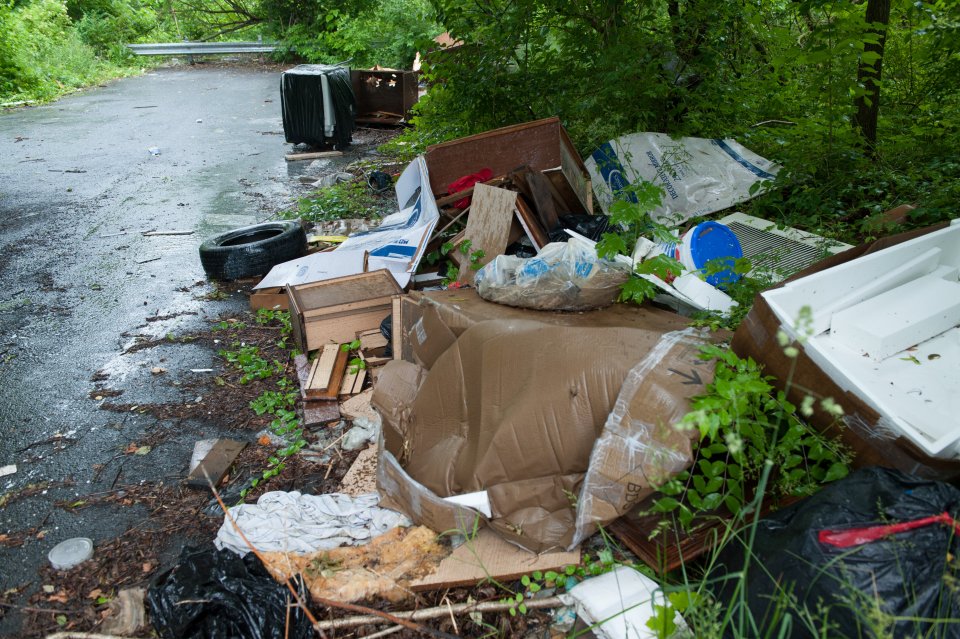 Large-scale trash on the side of a wet road