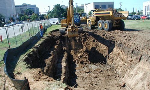 This is a picture of a backhoe digging in the soil during a Resource Conservation and Recovery Act corrective action cleanup.