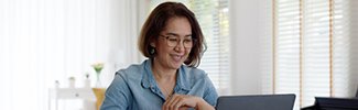 This is photo of a woman sitting in front of a computer.