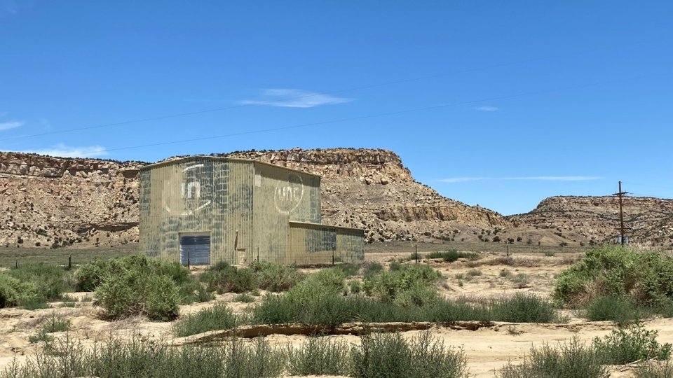 Former Ion Exchange Building facing Northwest - green industrial building in a desert landscape