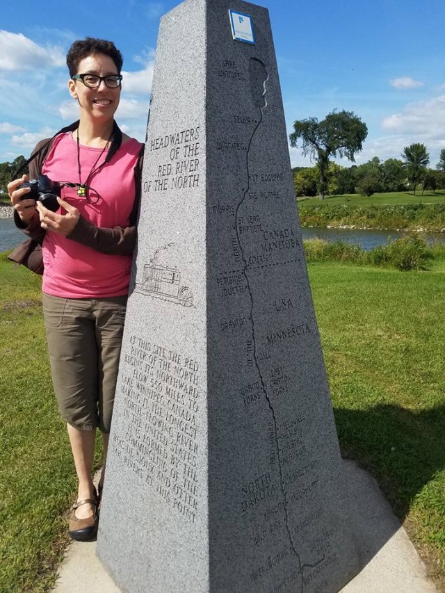 Katie Williams next to a statue 