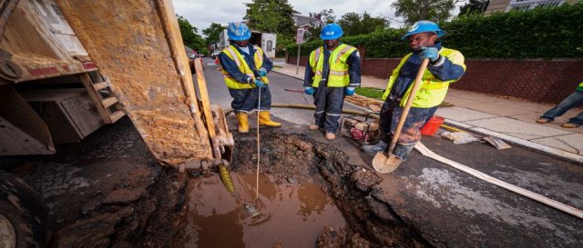 workers looking at water pipe