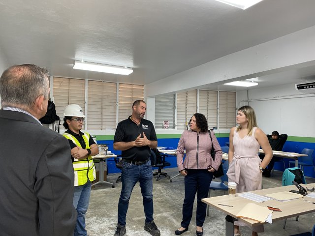 Figure 2 EPA Regional Administrator Lisa Garcia visits a job training facility and stands with other tour participants listening to a representative talking about the facility.