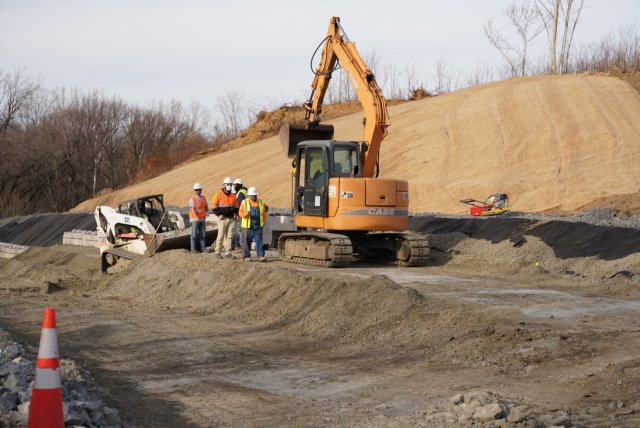 Heavy duty construction equipment in front of a hill