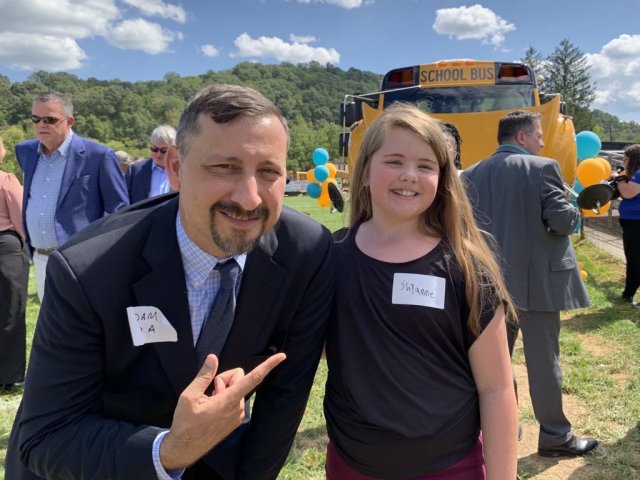 EPA Regional Admin. Adam Ortiz smiling with a student.