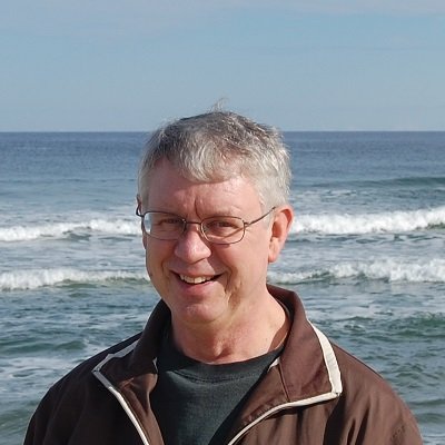 man smiling standing on the beach