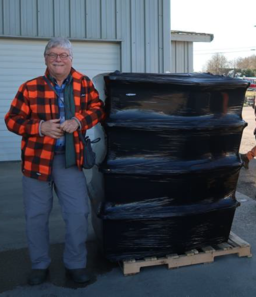 Researcher Mark Johnson with totes of biochar fresh off the barge