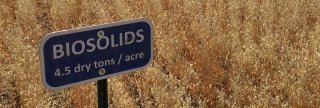 Sign in field that says: "Biosolids. 4.5 dry tons/acre"