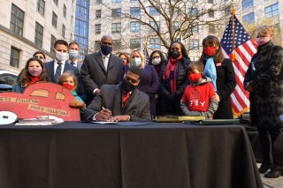 Administrator Regan signing an official document