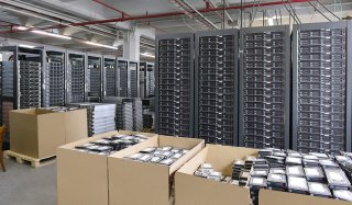 Wide shot of electronics in cardboard boxes for recycling. 