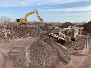 Image of heavy machinery in a barren field. 