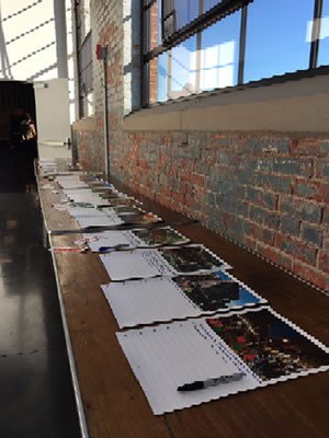 Sign in sheets on tables at a Brownfields planning workshop at the WaterFire Arts facility.