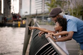 Young child and grandparent observe something outside of the frame.