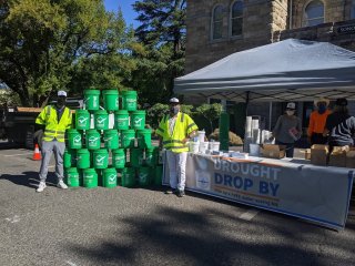 People giving out buckets at "Drought Drop-By"