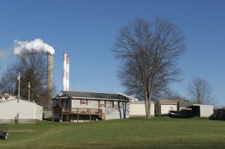 Photo of home with a power plant in the background