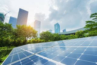 solar panels with tall buildings in distance