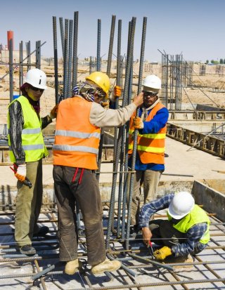 Steel rebar being inserted on a construction site