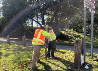 Workers taking soil samples in the East Palestine Village Park