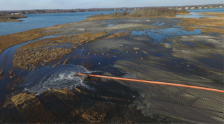 An aerial view showing sediment being placed on the marsh.