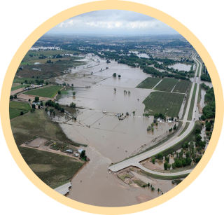 A photo from an aerial view of farmland and roads underwater after a flood.