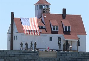 Guards stand in front of Wood Island’s Life Saving Station restored building. (photo credit: WILSSA)