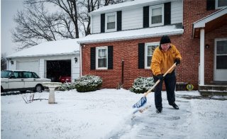 man shoveling snow from walkway