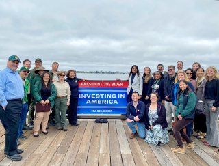 EPA and Project Partners at a 2023 Press Event Oakland, CA. posing on waterfront peir with Investing in America banner.