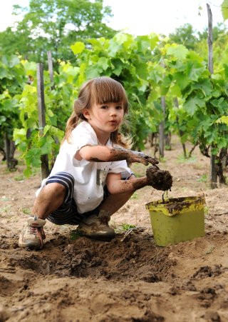 Young girls plays with mud