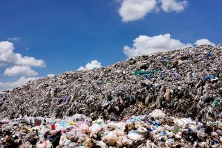 stock image of a landfill overflowing with trash and waste