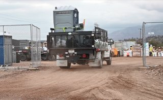 A truck with sealed and bagged waste materials entering an EPA staging area.