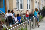 Young people sitting on front steps